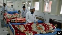 Doctors assist wounded in a hospital after they were injured in a suicide attack, in Jalalabad, capital of Nangarhar province, Afghanistan, Jan. 17, 2016. The United Nations urged on Feb. 23, 2016, the warring sides in Afghanistan to respect "the provision of healthcare, never to harm medical personnel and patients."
