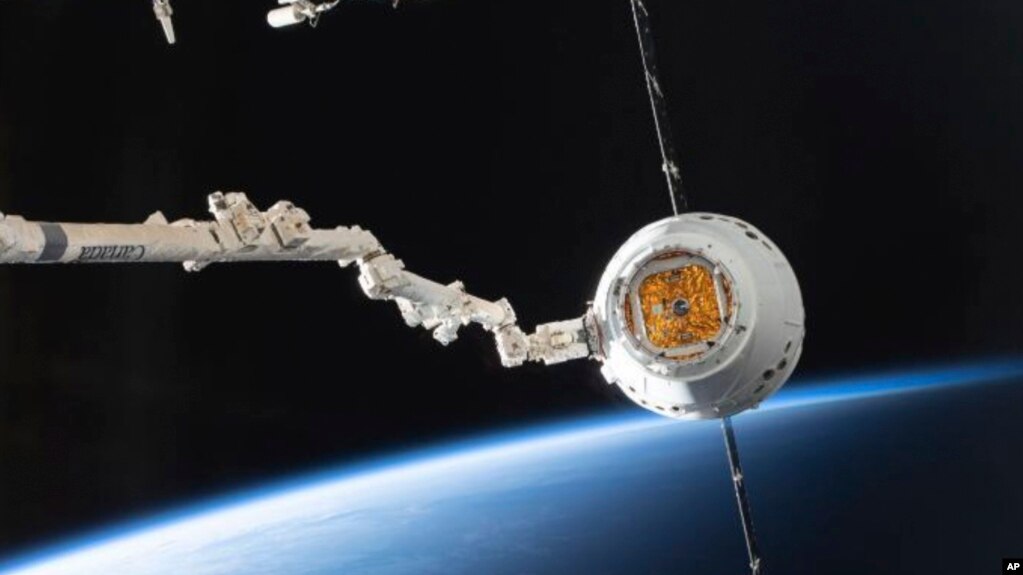 In this image provided by NASA, the SpaceX Dragon capsule arrives at the International Space Station, Sunday, Dec. 8, 2019. Some researchers are proposing an orbital tax to prevent ｃountries from launching too many objects into space.