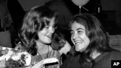 FILE - In this May 21, 1979 file photo, feminist activist Kate Millett, right, laughs, during a surprise birthday party for her niece, Kristan Vigard, in New York.