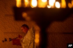 FILE—Priest Ivan, chaplain of the 72nd Separate Mechanized Brigade of the Ukrainian army, leads a Christian Orthodox Easter religious service, in Donetsk region, Ukraine, Saturday, May 4, 2024.