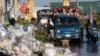 Trucks carry workers on a flooded street as the daily transportation brings them to home from work near Trapang Anchanh village, outside Phnom Penh, Cambodia, Saturday, Oct. 27, 2018. (AP Photo/Heng Sinith)