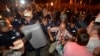 Protesters clash with Bulgarian riot police during an anti-government protest in front of the parliament building in Sofia, July 23, 2013. 