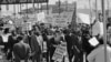 FILE - Part of the group of marchers, estimated at over 2,000 parade through downtown Dallas, Texas on March 14, 1965, in support of the African American voter registration in Selma, Alabama. 