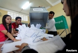 Officials begin the process of counting ballots after polls have closed in Cambodia's general election, at a polling station in Phnom Penh, Cambodia July 29, 2018.