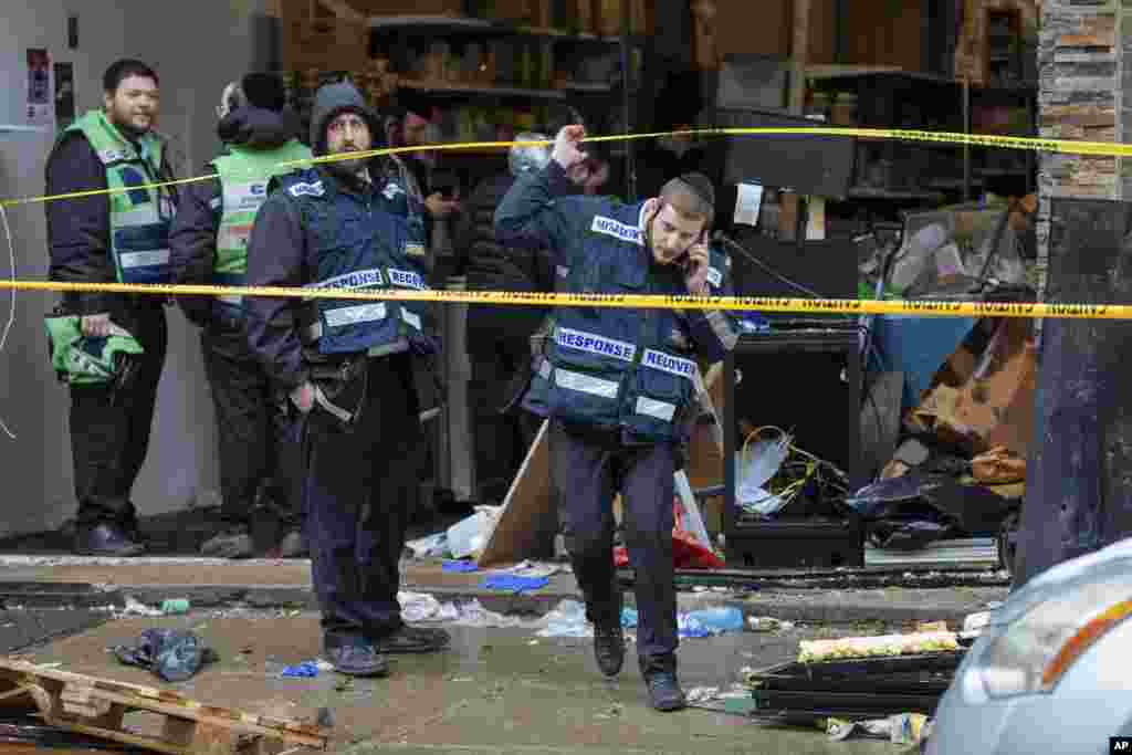 Responders work to clean up the scene of Tuesday&#39;s shooting that left multiple people dead at a kosher market in Jersey City, New Jersey.