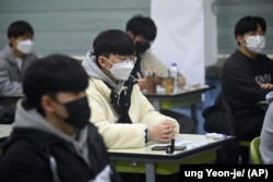 South Korean students wait for the start of their College Scholastic Ability Test in an exam hall at a high school in Seoul Thursday, Nov. 18, 2021