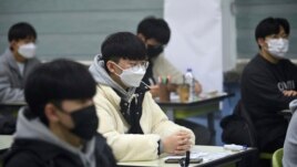 South Korean students wait for the start of their College Scholastic Ability Test in an exam hall at a high school in Seoul Thursday, Nov. 18, 2021