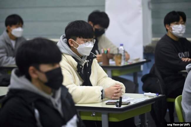 South Korean students wait for the start of their College Scholastic Ability Test in an exam hall at a high school in Seoul Thursday, Nov. 18, 2021