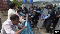 FILE - Pakistani police try to stop journalists during a rally to mark World Press Freedom Day in Islamabad on May 3, 2018.