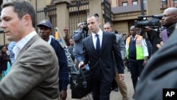 Oscar Pistorius, center, leaves after the court adjourned for the day in Pretoria, South Africa, on May 6, 2014. 