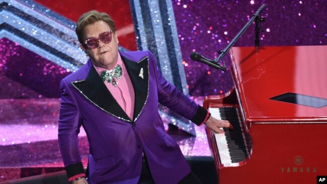 FILE - In a Sunday, Feb. 9, 2020 file photo, Elton John performs "(I'm Gonna) Love Me Again" nominated for the award for best original song from "Rocketman" at the Oscars, at the Dolby Theatre in Los Angeles.