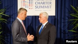 FILE - U.S. Vice President Mike Pence and Kosovo's President Hashim Thaci speak during a photo opportunity at the Adriatic Charter Summit in Podgorica, Montenegro, Aug. 2, 2017.