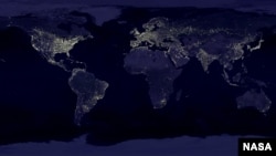 A satellite view of Earth showing the distribution of lights throughout the industrialized and developing worlds. This lighting overpowersbsdrowns out the night sky for the growing number of people who live in those areas. (NASA) 