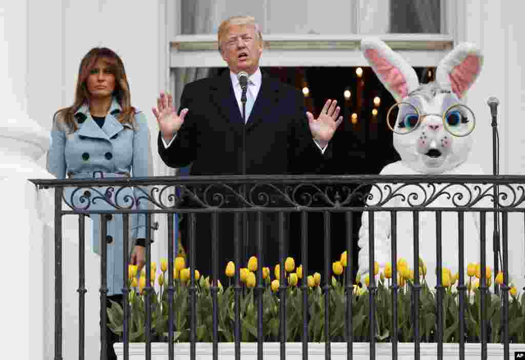 President Donald Trump, joined by the Easter Bunny and first lady Melania Trump, speaks from the Truman Balcony of the White House in Washington, Monday, April 2, 2018, during the annual White House Easter Egg Roll. (AP Photo/Carolyn Kaster)
