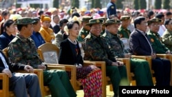 Aung San Suu Kyi sits amid military representatives at the 70th anniversary of the Panglong Agreement, Feb. 12, 2017. (Facebook/ Myanmar State Counsellor)