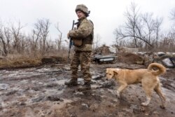 A Ukrainian soldier walks on the line of separation from pro-Russian rebels, Donetsk region, Ukraine, Jan. 10, 2022.