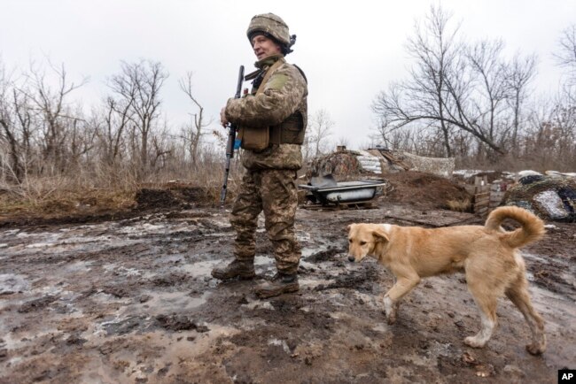 A Ukrainian soldier walks on the line of separation from pro-Russian rebels, Donetsk region, Ukraine, Jan. 10, 2022.