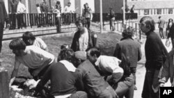 A Kent State University student lies on the ground after National Guardsman fired into a crowd of demonstrators on May 4, 1970 in Kent, Ohio. (AP Photo)