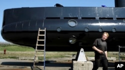 FILE - Submarine owner-builder Peter Madsen is seen with his craft in a April 30, 2008, photo.