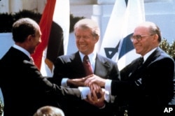 In this March 26, 1979, file photo, Egyptian President Anwar Sadat, left, U.S. President Jimmy Carter, center, and Israeli Prime Minister Menachem Begin clasp hands on the North lawn of the White House as they completed signing of the peace treaty