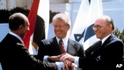 In this March 26, 1979, file photo, Egyptian President Anwar Sadat, left, U.S. President Jimmy Carter, center, and Israeli Prime Minister Menachem Begin clasp hands on the North lawn of the White House as they completed signing of the peace treaty