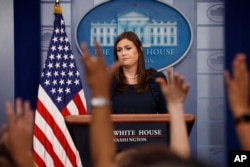 FILE - White House Press Secretary Sarah Huckabee Sanders listens to a question during the daily press briefing at the White House in Washington, Aug. 1, 2017.