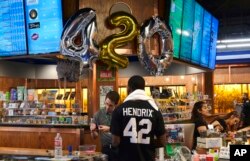 Customers gather around a counter to take advantage of special deals celebrating the 4/20 holiday at ShowGrow, a medical marijuana dispensary in downtown Los Angeles, April 20, 2017.