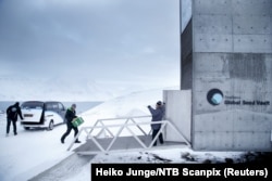 FILE - One of the newly arrived boxes containing seeds from Japan and the U.S. is carried into the international gene bank Svalbard Global Seed Vault (SGSV) outside Longyearbyen on Spitsbergen, Norway, March 1, 2016.