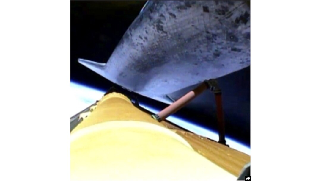 The space shuttle Atlantis releases its fuel tank for the final time, July 8, 2011