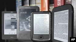 The Kobo eReader Touch, an Amazon Kindle, an Aluratek Libre Air, and a Barnes & Noble Nook, left to right, are displayed in this photo, in New York, Tuesday, June 14, 2011. Today, e-book readers, including a Kindle, can be purchased for just over $100. (AP Photo/Richard Drew)
