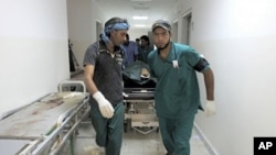 Body of a NTC fighter is wheeled into a hospital after an ambush by pro-Gaddafi forces in Ras Lanuf on September 12, 2011.