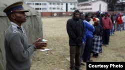 Voters waiting to vote outside a polling station in Harare