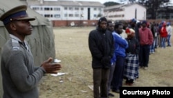Voters waiting to vote outside a polling station in Harare