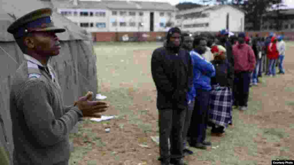 Voters waiting to vote outside a polling station in Harare