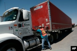 An employee fuels up a truck with a cargo trailer loaded with goods to import, at the "Fletes Sotelo" moving company, in Ciudad Juarez, Mexico, June 7, 2019. Companies were rushing to ship as many goods as possible out of Mexico to get ahead of possible tariffs threatened by President Donald Trump.