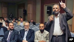 Jamal Al Wadi from the Syrian city of Daraa speaks as Syrian opposition members listen after they announced a Syrian National Council in their bid to present a united front against President Bashar al-Assad's regime, in Istanbul, Turkey, September 15, 201