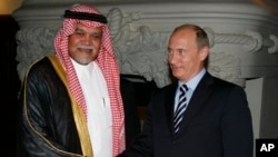 FILE - Russian Prime Minister Vladimir Putin greets Head of Saudi Arabia's National Security Council Prince Bandar bin Sultan.