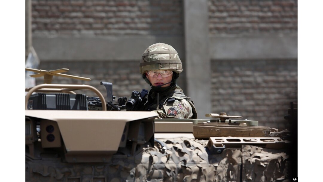 FILE - A U.S. soldier guards a site near Kabul's international airport in Kabul, Afghanistan, May 17, 2015.