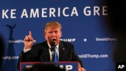 Republican presidential candidate Donald Trump gestures while speaking at a town hall meeting at Atkinson Country Club in Atkinson, New Hampshire, Oct. 26, 2015. 