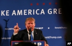 Republican presidential candidate Donald Trump gestures while speaking at a town hall meeting at Atkinson Country Club in Atkinson, New Hampshire, Oct. 26, 2015.