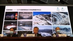 FILE - Liu Yumin, center, head of planning and construction for the Beijing Organizing Committee for the Beijing 2022 Olympics, speaks during a news conference about construction progress event venues, at committee headquarters in Beijing, July 30, 2021.