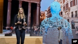 Megan Saunders, Microsoft's general manager, describes the capabilities of Paint 3D as Taj Reid experiences virtual reality at a Microsoft media event in New York, Oct. 26, 2016.