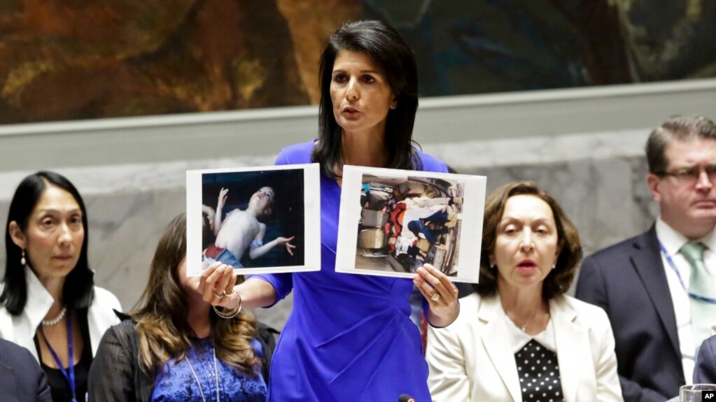 U.S. Ambassador to the United Nations Nikki Haley shows pictures of Syrian victims of chemical attacks as she addresses a meeting of the Security Council on Syria at U.N. headquarters, in New York, April 5, 2017. 