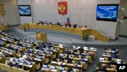 FILE - Russian lawmakers vote at the State Duma, the Lower House of the Russian Parliament in Moscow, Nov. 15, 2017. 