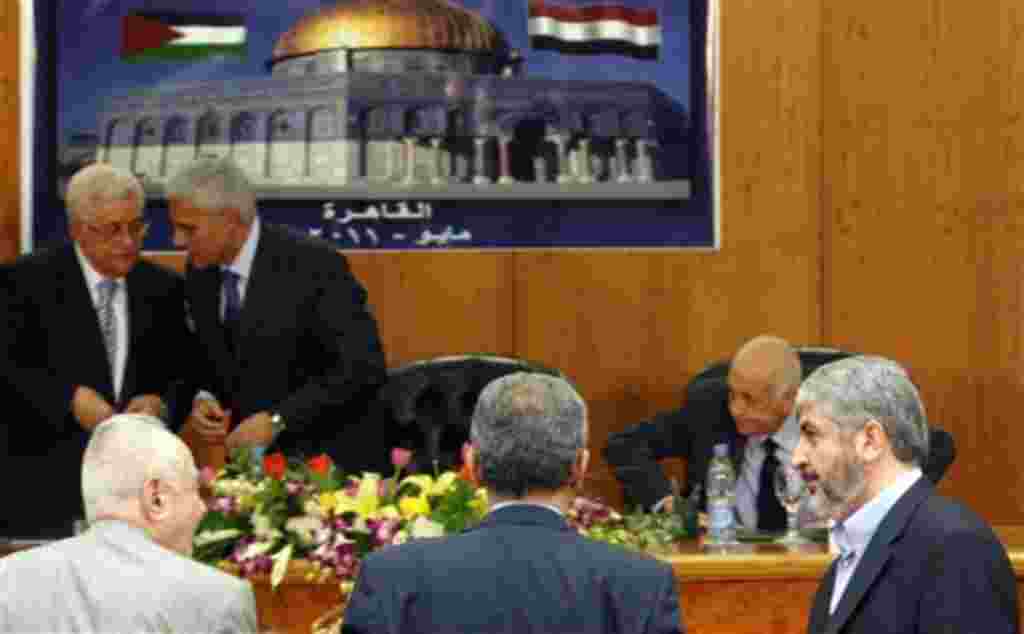 Khaled Mashaal, Damascus-based leader of Hamas, foreground right, after giving his speech as Palestinian President Mahmoud Abbas, background left, speaks to Egypt's intelligence chief Murad Mewafi, during the reconciliation celebration in Cairo, Egypt, We