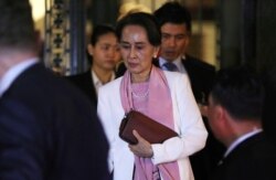 FILE - Myanmar's leader Aung San Suu Kyi leaves the International Court of Justice (ICJ), the top United Nations court, after court hearings in a case filed by Gambia against Myanmar alleging genocide against the minority Muslim Rohingya population.