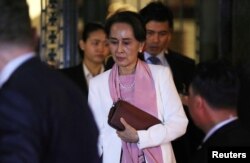 FILE - Myanmar's leader Aung San Suu Kyi leaves the International Court of Justice (ICJ), the top United Nations court, after court hearings in a case filed by Gambia against Myanmar alleging genocide against the minority Muslim Rohingya population.
