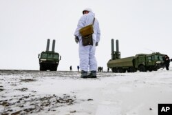 FILE - An officer stands near Bastion anti-ship missile systems on the Alexandra Land island near Nagurskoye, Russia, May 17, 2021.
