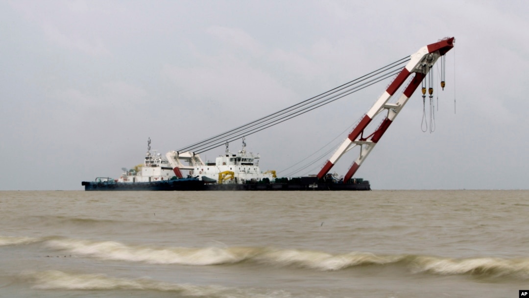 Pihak berwenang Bangladesh berusaha mengangkat kapal feri yang tenggelam di sungai Padma (5/8).