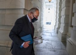U.S. Senate Majority leader Chuck Schumer, D-NY, carries his empty lunch box back into the Capitol as the Senate continues to work through the bipartisan infrastructure bill, in Washington, August 9, 2021.